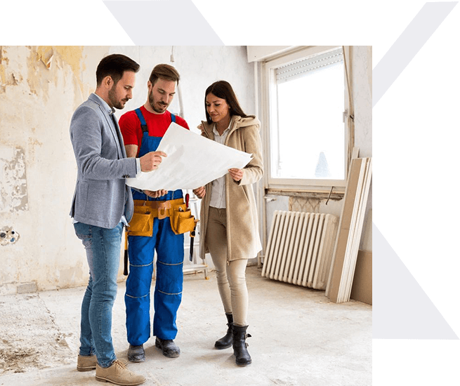 A group of people standing around looking at plans.