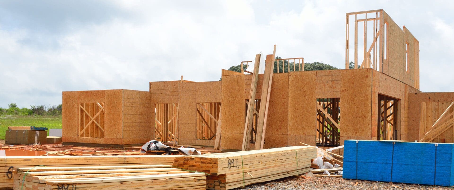 A pile of wood sitting in front of a building.