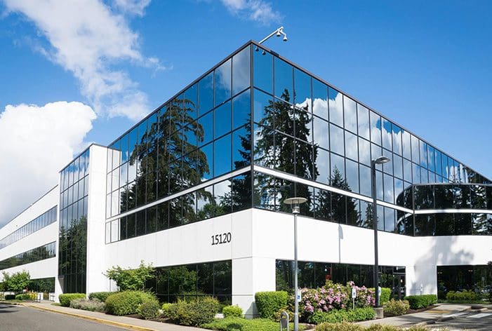 A building with many windows and trees in front of it