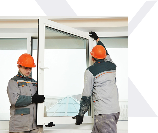 Two men in hard hats are working on a window.